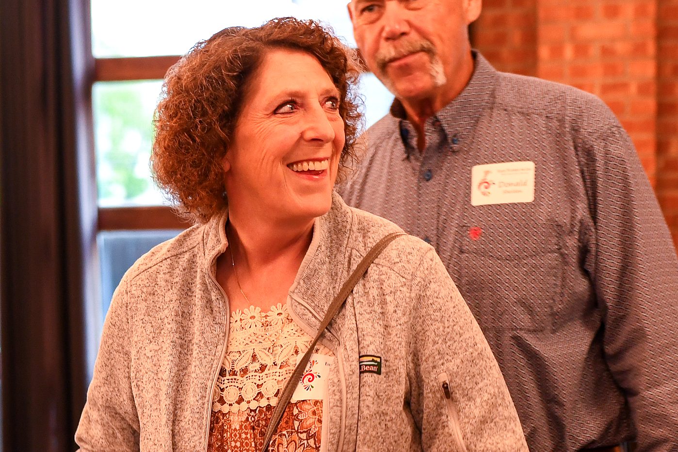 A guest smiling with a member of the team at the firm's 2026 annual client meeting