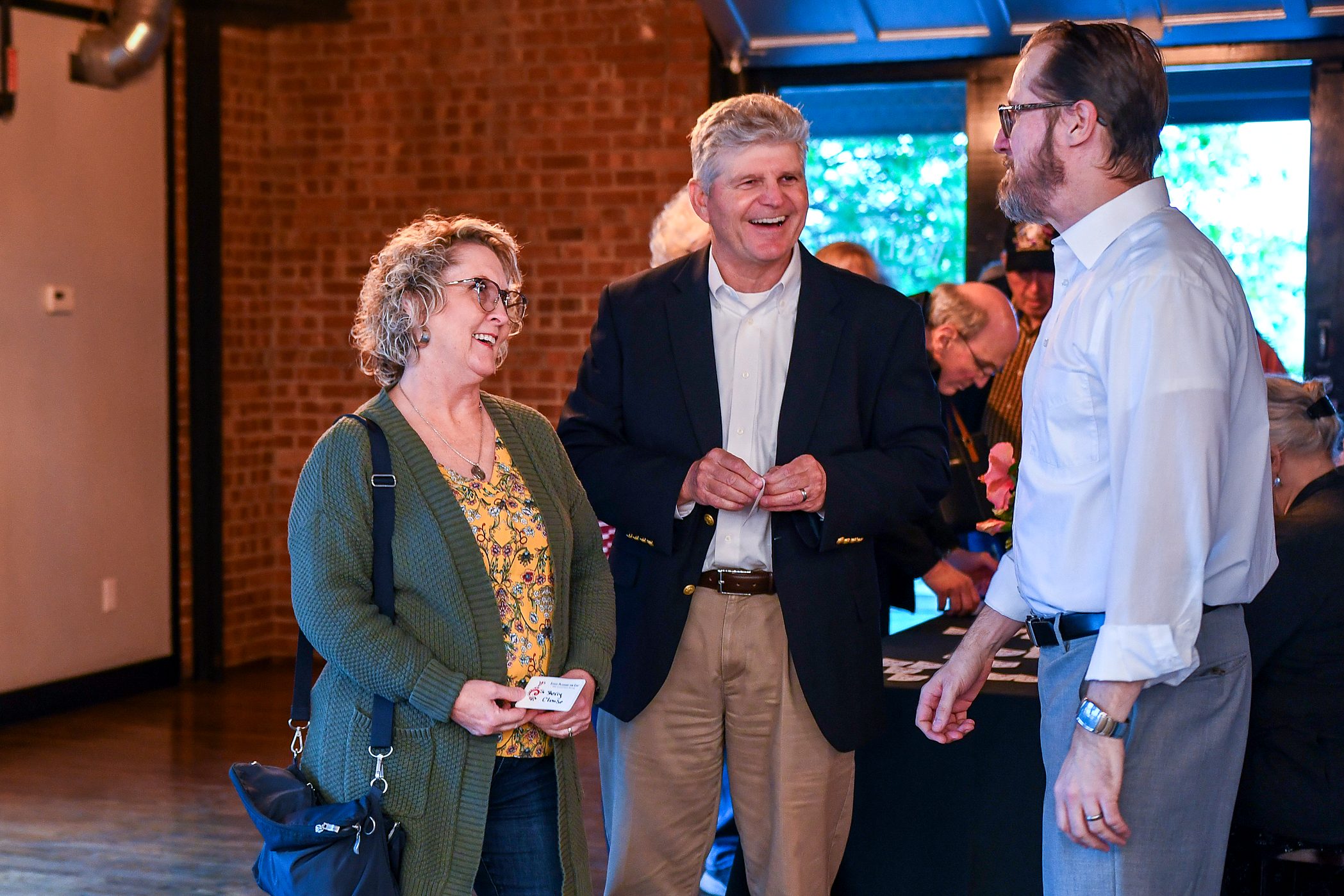 Guests laughing together at the firm's 2026 annual client meeting