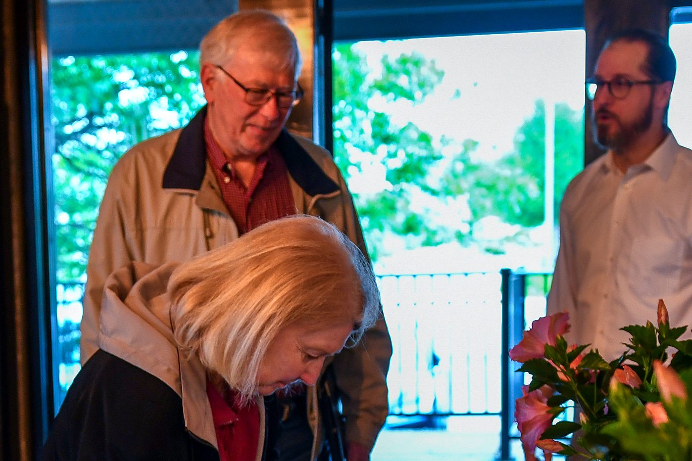 Signing in beside the flowers at the firm's 2026 annual client meeting