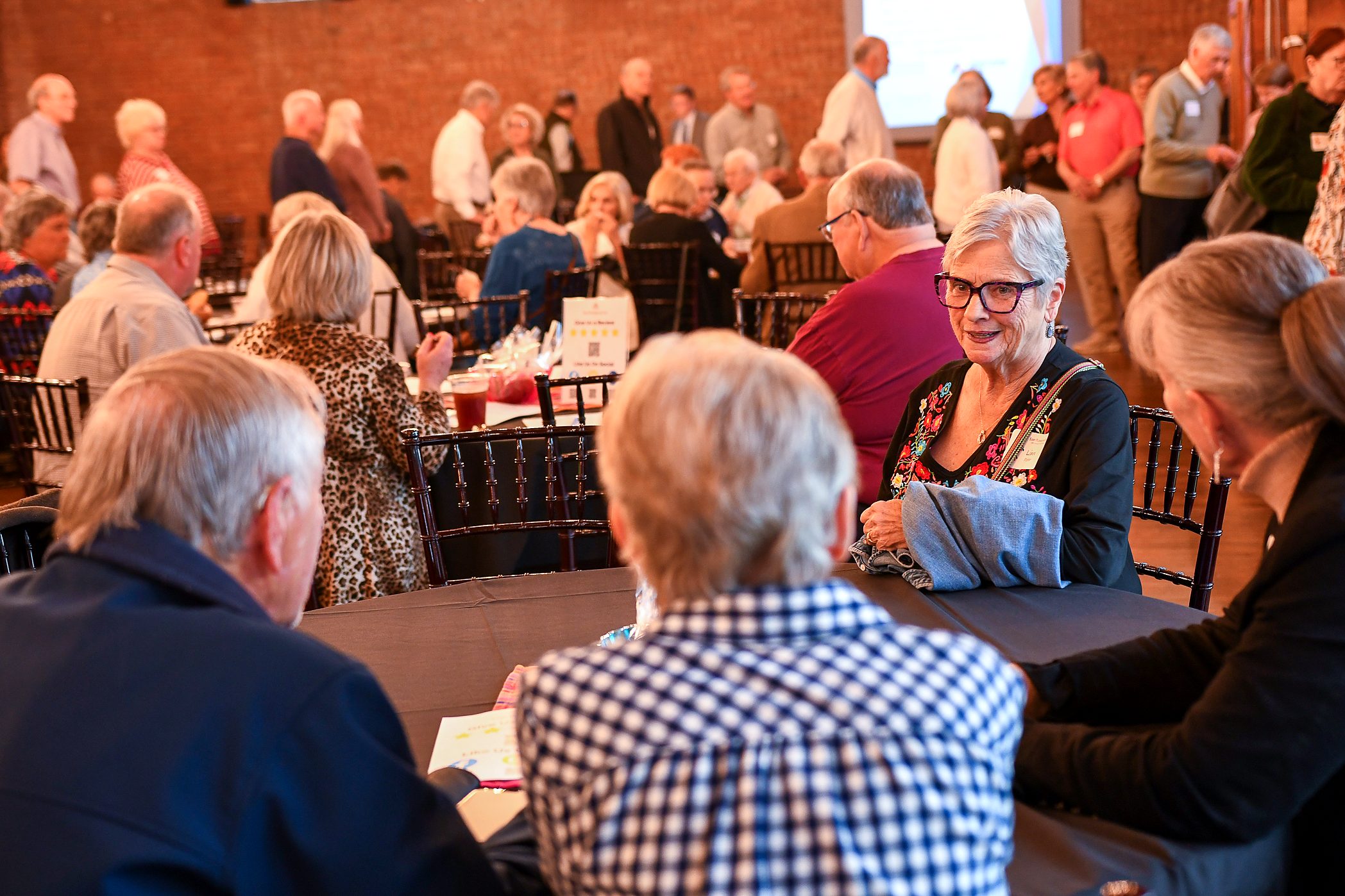 Client families at their table at the firm's 2026 annual client meeting
