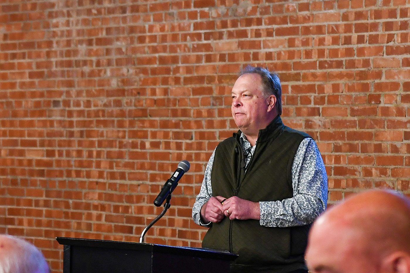 At the podium at the firm's 2026 annual client meeting
