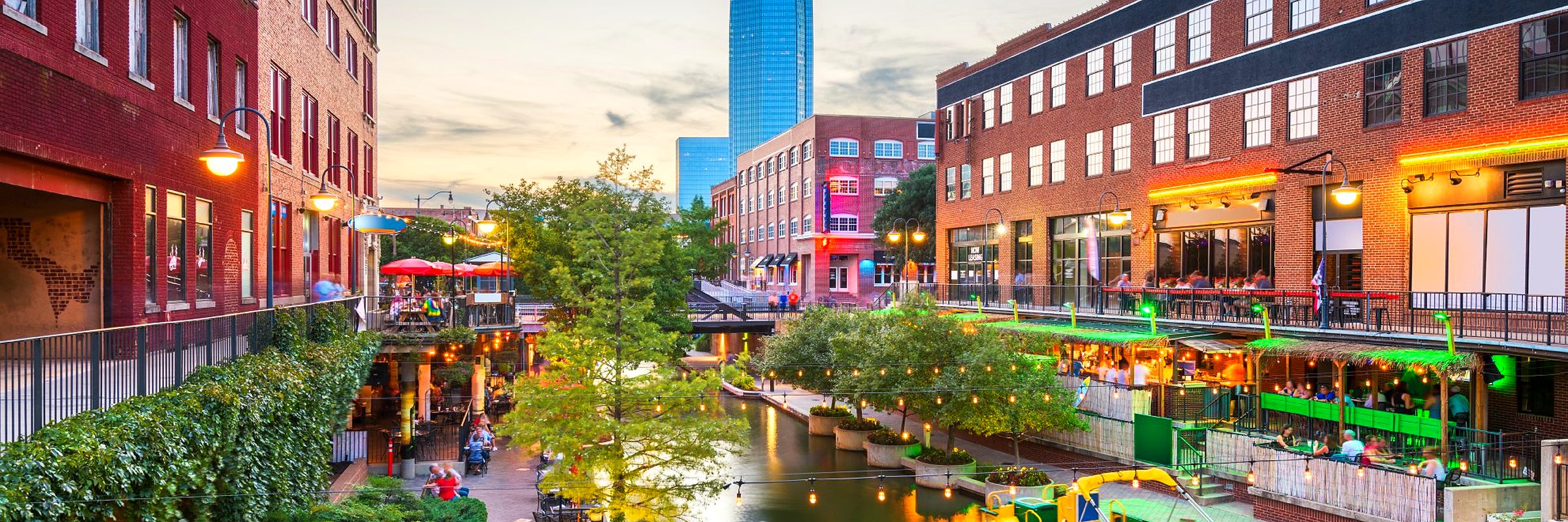 The Bricktown canal in Oklahoma City at dusk, the Devon Tower beyond