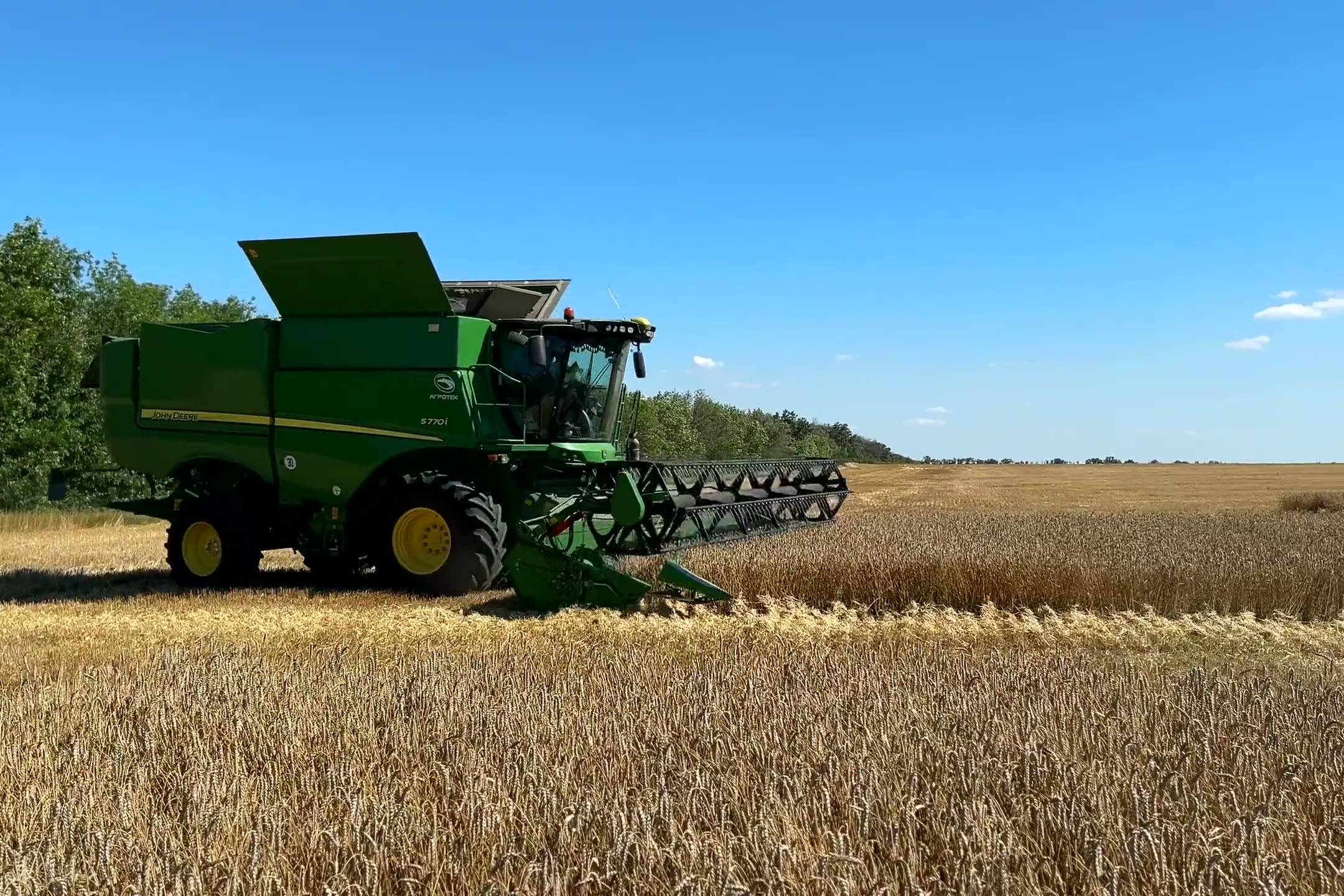 Golden Oklahoma wheat at harvest, the first frame of a film of the land, homes and families the firm plans for