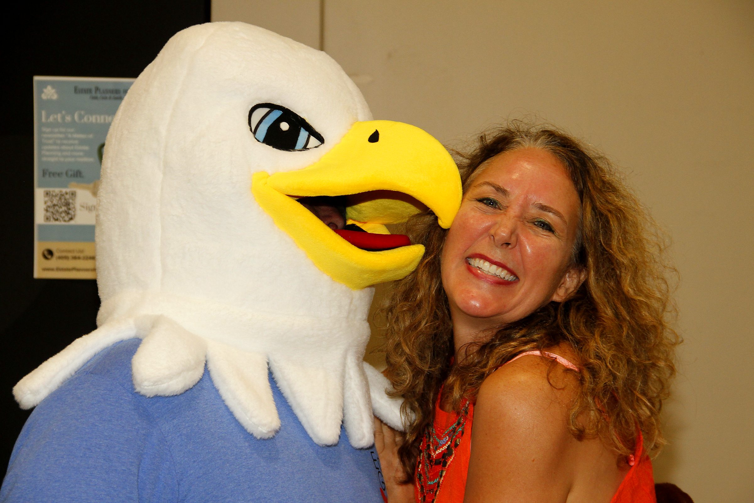A member of the team with the expo's eagle mascot at a community senior expo