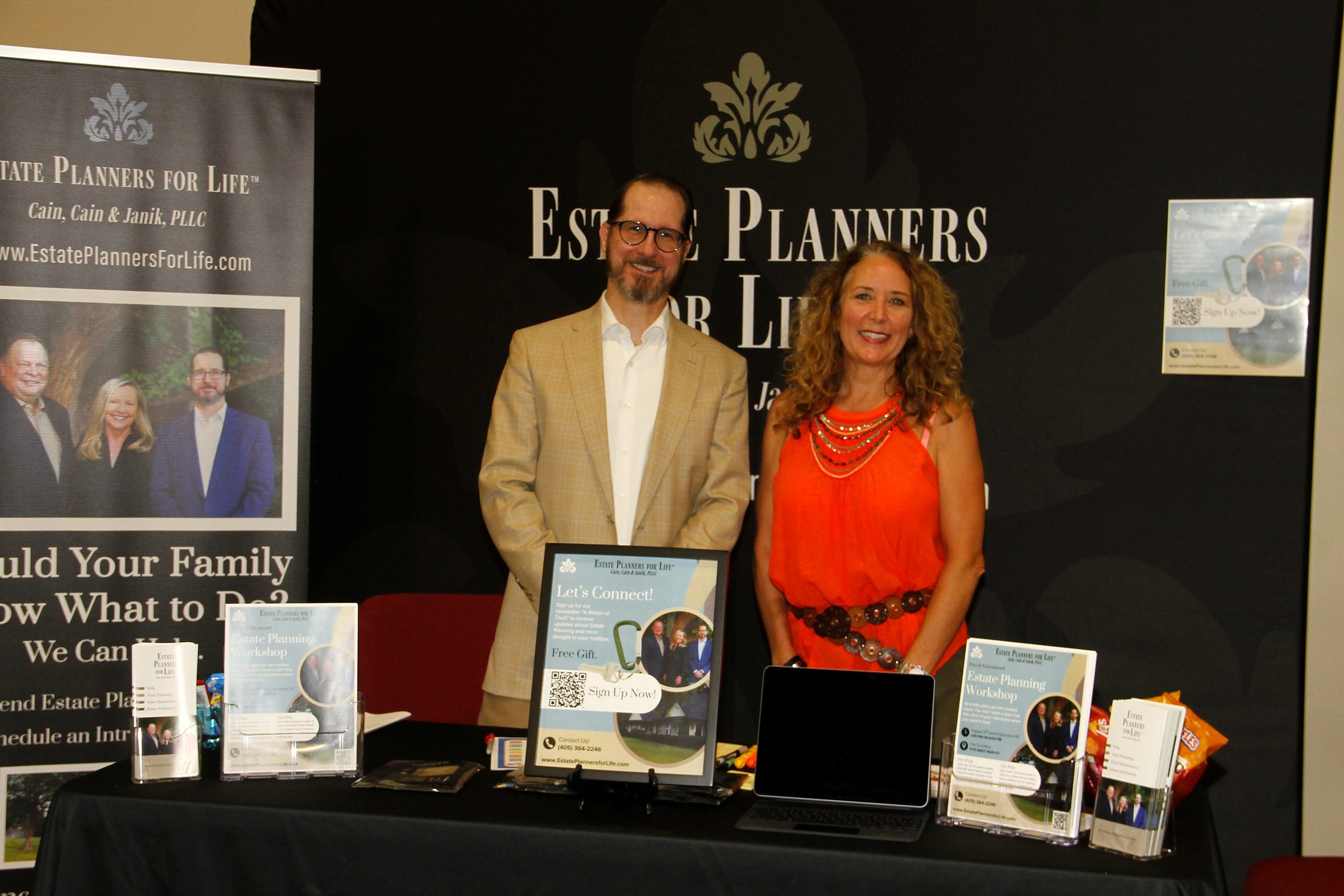 Mitch Janik and a member of the team behind the firm's booth at a community senior expo
