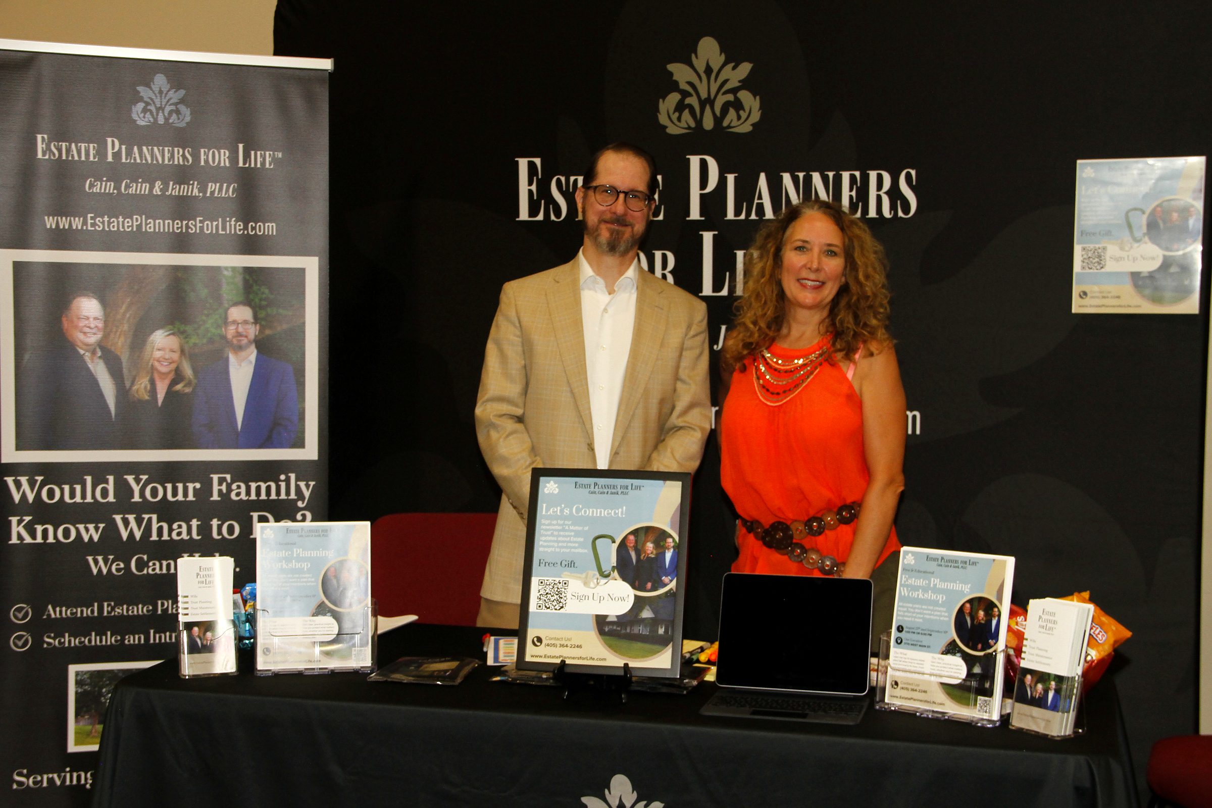 Mitch Janik and a member of the team at the firm's booth at a community senior expo