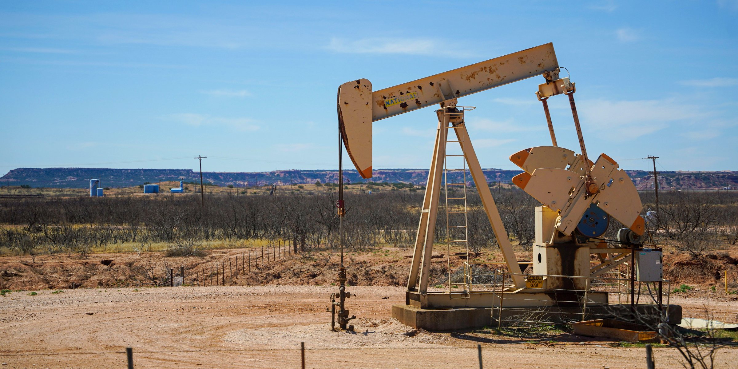 A pump jack at work on open ground