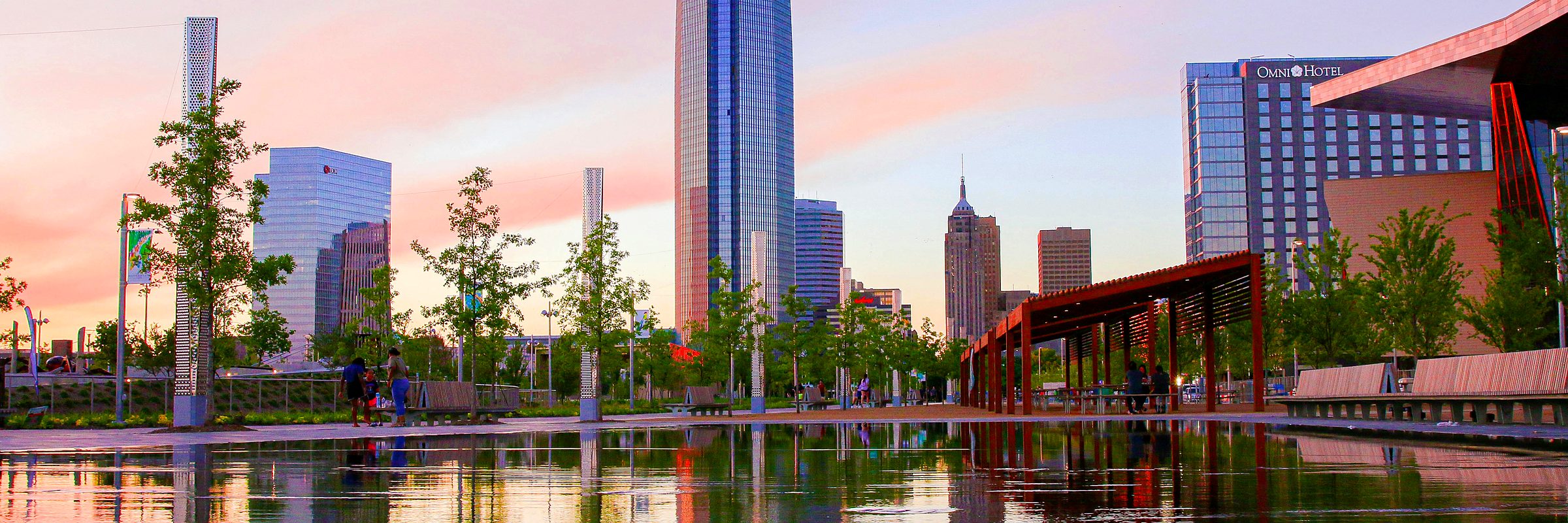 Scissortail Park at sunset, the Devon Tower and the Oklahoma City skyline reflected in the water