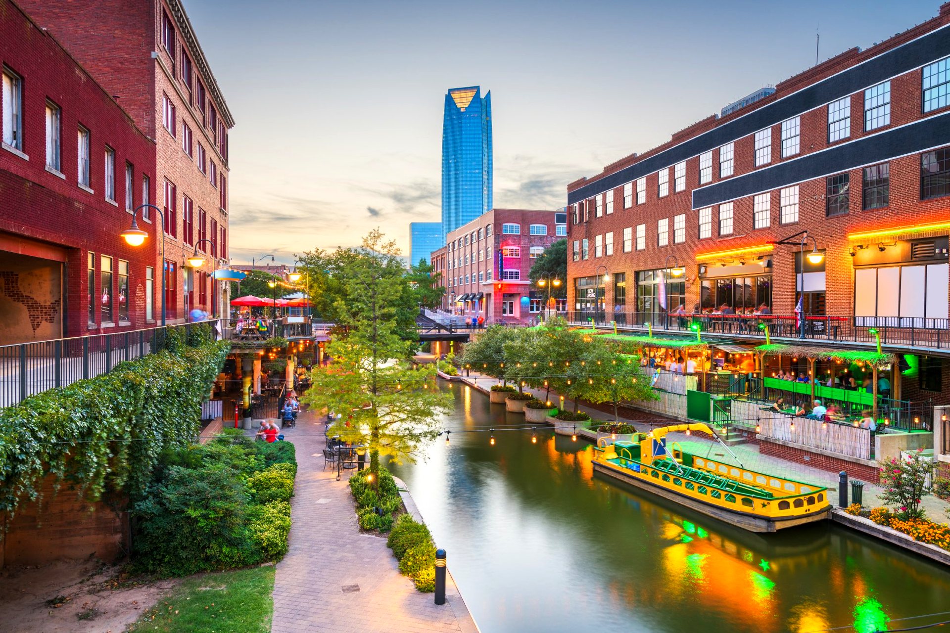 The Bricktown canal in Oklahoma City at dusk, the Devon Tower beyond